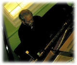 John Abercrombie playing piano.